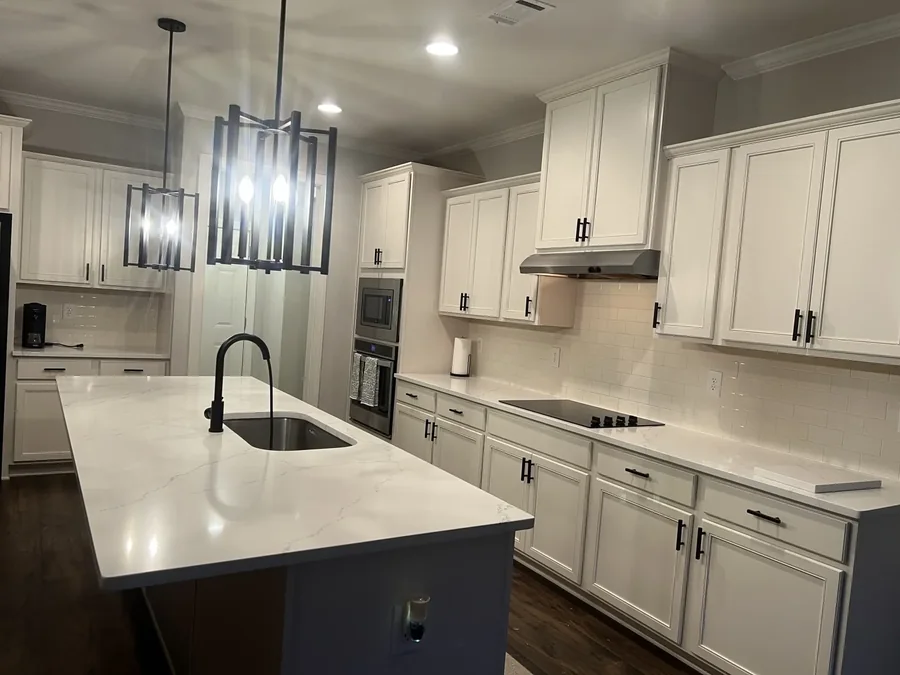 Bright white quartz kitchen with white cabinetry
