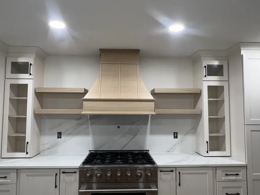 Slab backsplash carried up the full range wall