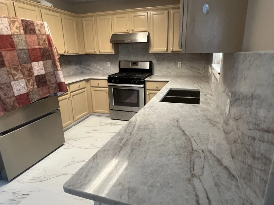 Full-height slab backsplash behind the cooktop