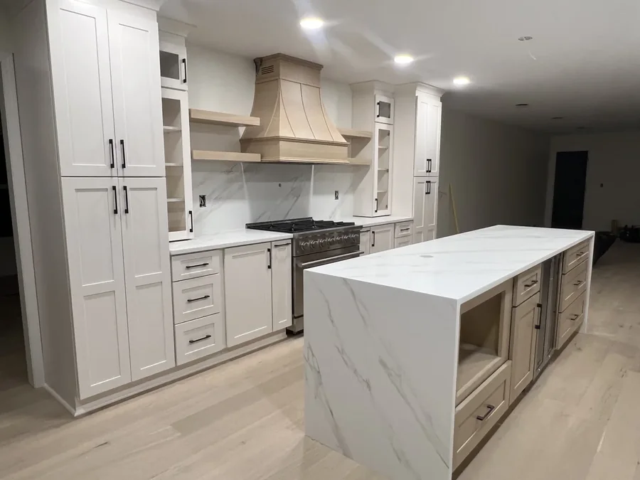 White quartz waterfall island in a bright kitchen