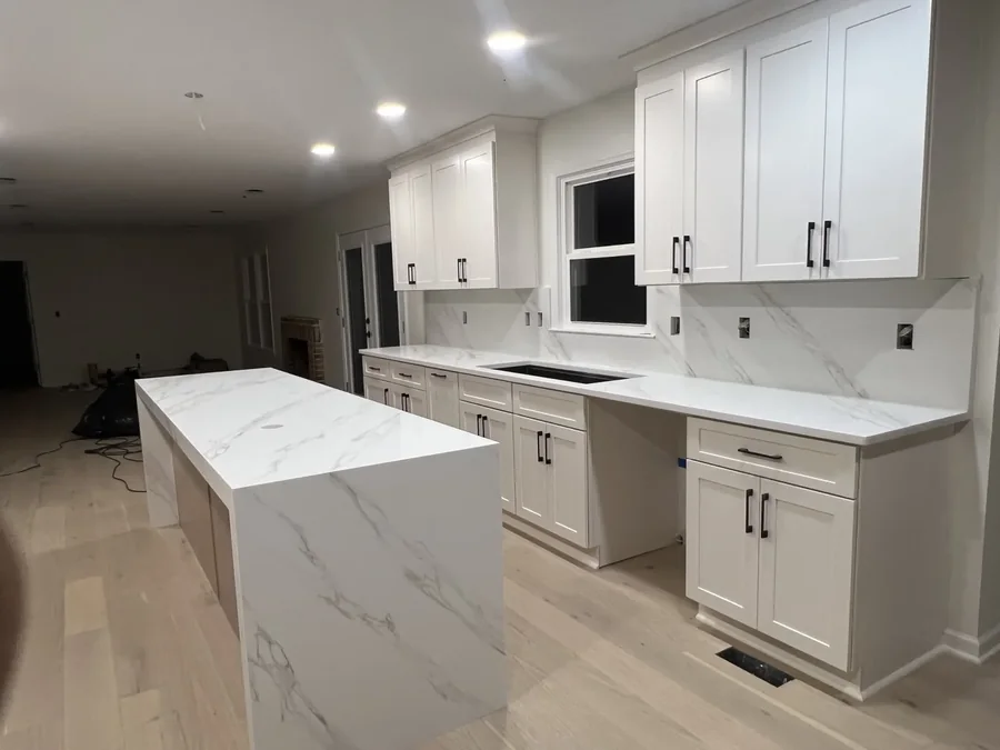 White quartz waterfall island with grey veining