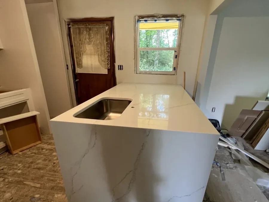 Waterfall panel meeting the countertop at a mitred seam