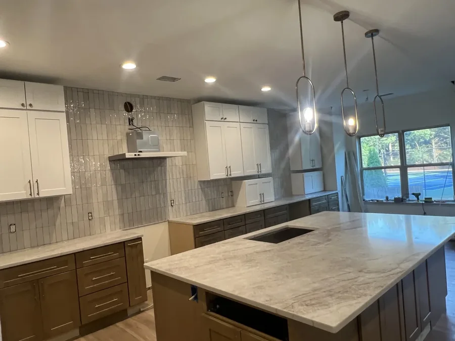 Veined quartz island under pendant lighting