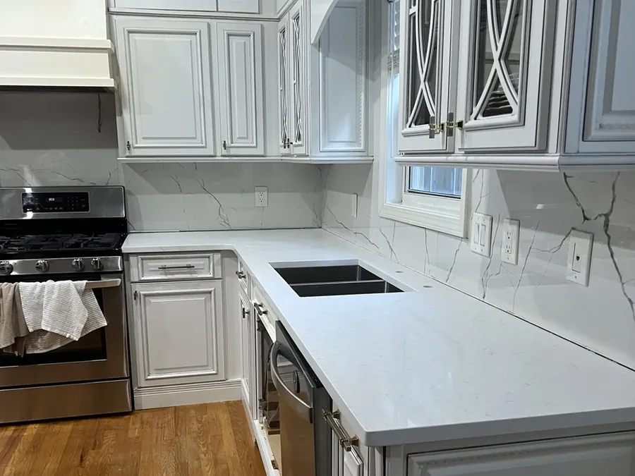 Galley kitchen finished in white quartz
