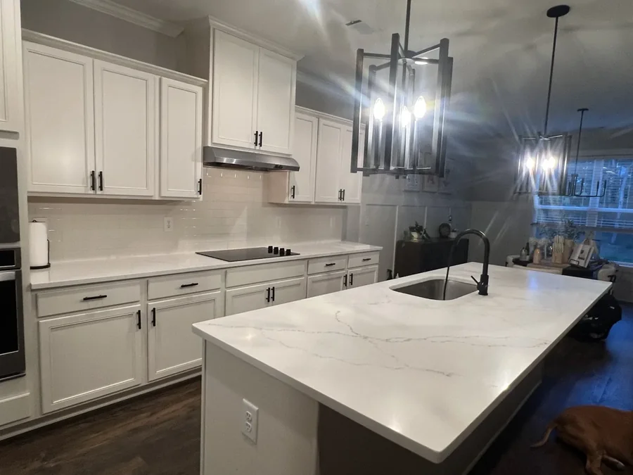 White quartz island paired with matte black fixtures